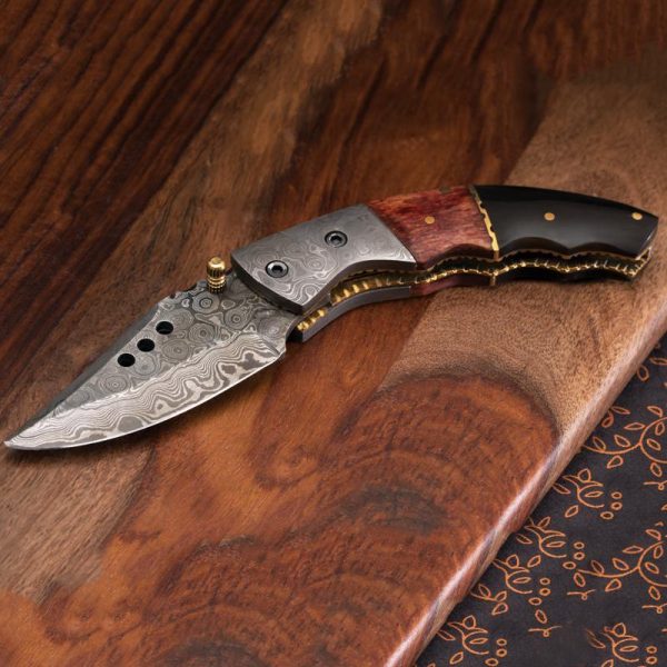 Damascus steel with rippled texture pattern on blade, one of best curved folding knife
